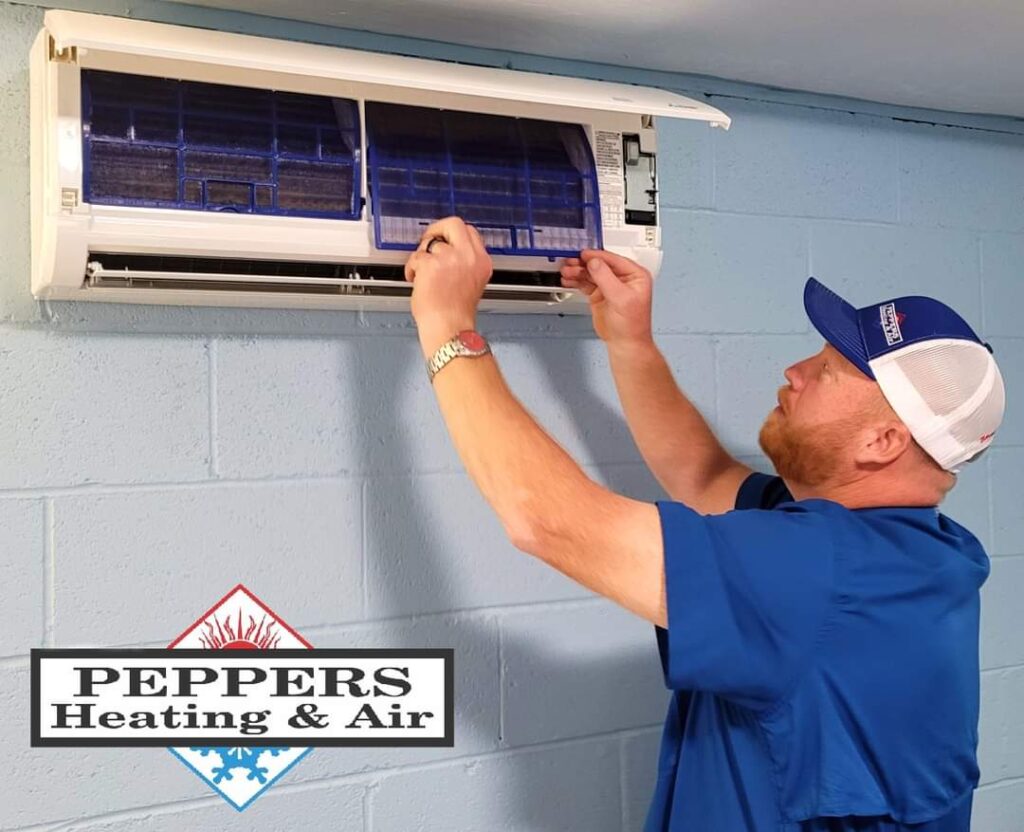 Peppers hvac tech changing filters in ductless ac