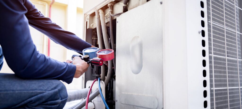 Technician is checking air conditioner ,measuring equipment for filling air conditioners
